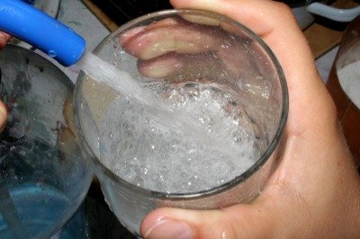 using a Soda Siphon to fill as glass with soda water