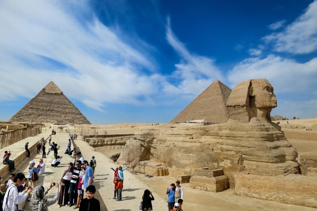 Tourists walk among the Gaza Pyramids