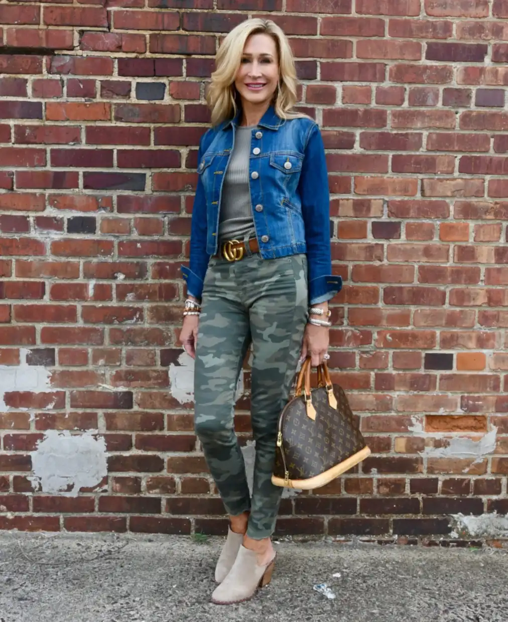 Blond lady in a stylish camouflage pant outfit.